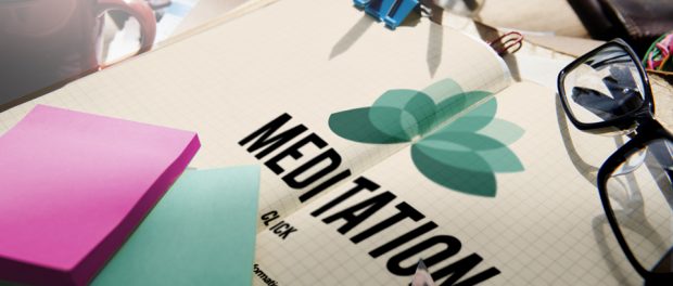 Image of a booklet an a pen on a desk that says mediation.