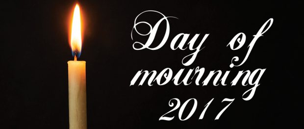 Image of a burning candle on black background with the words Day of mourning 2017 beside it.