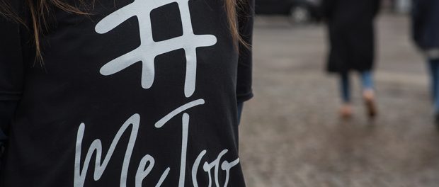 Photo of a person wearing t-shirt with #MeToo written on it.