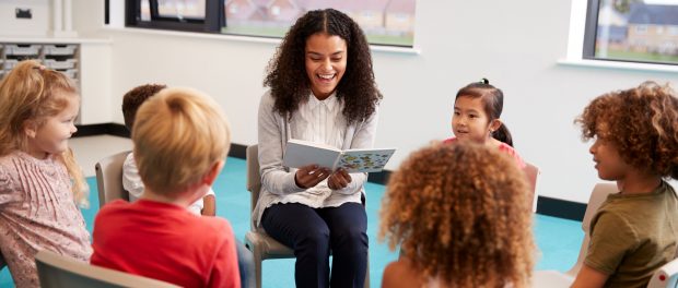 Photo of teacher reading to children in a classroom