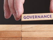 Photo of hand showing a block with the word: Governance