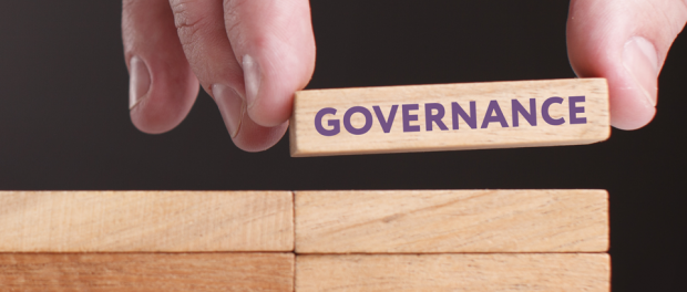 Photo of hand showing a block with the word: Governance