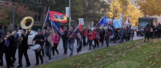 Photo of protesters marching at Queen's Park