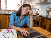 Stressed business woman working from home on laptop looking worried