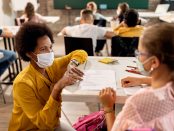Education support day teacher in classroom masked