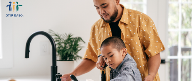 kid doing the dishes with his dad