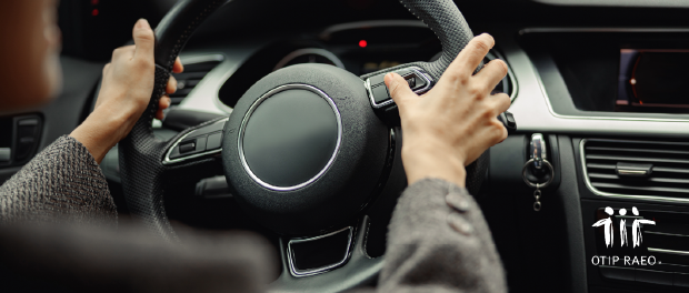 Hands holding a steering wheel in a car